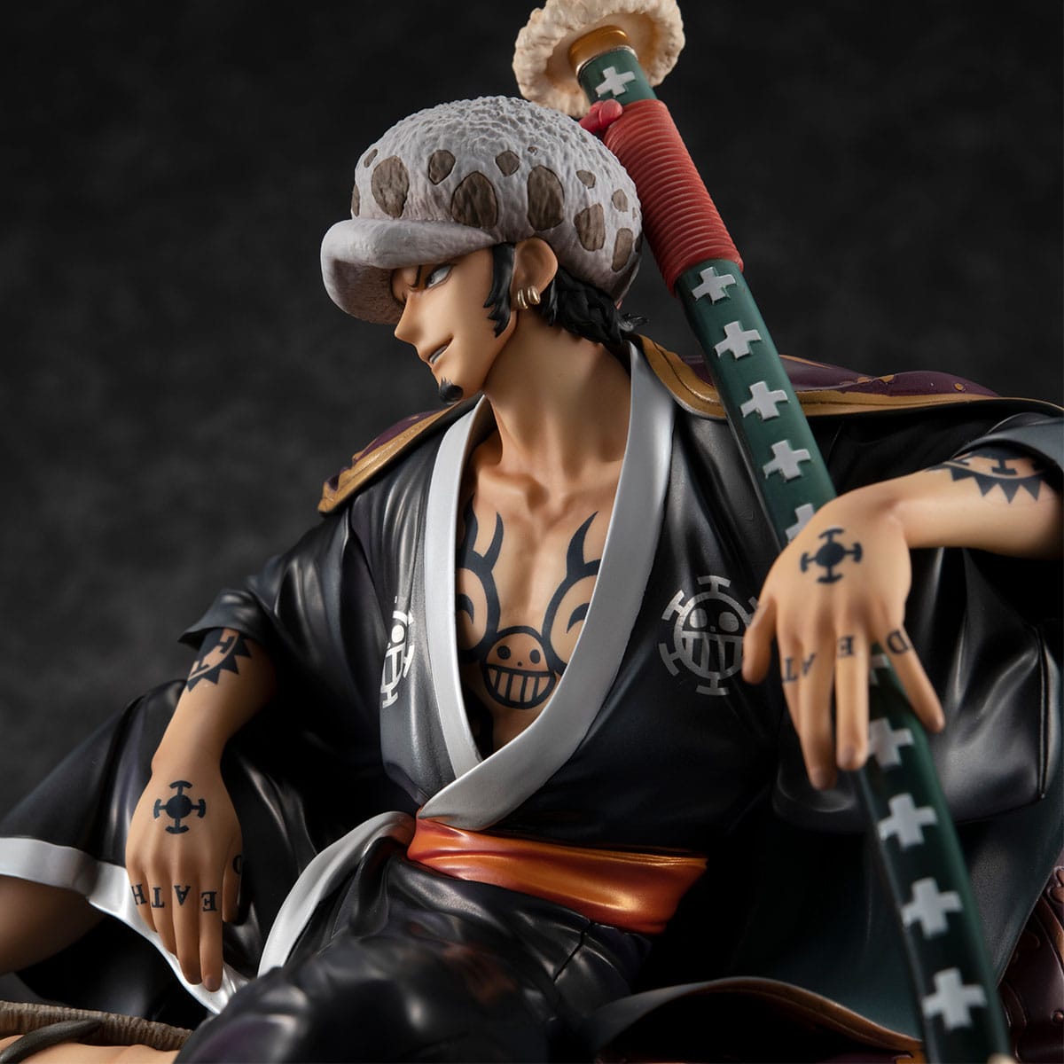 Figurine de Trafalgar Law, capitaine des Heart Pirates, tenant son gigantesque sabre avec des effets de lumière bleutée, fabriquée par MEGAHOUSE.