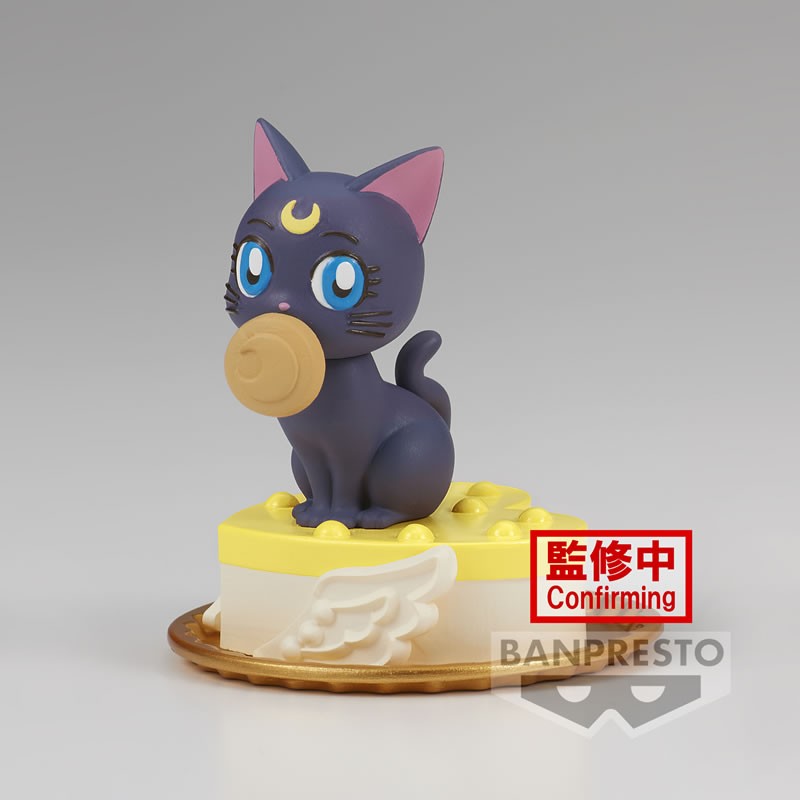 Vue 3/4 avant en plan d'ensemble de la figurine de Luna de Sailor Moon tenant un objet circulaire dans sa bouche.