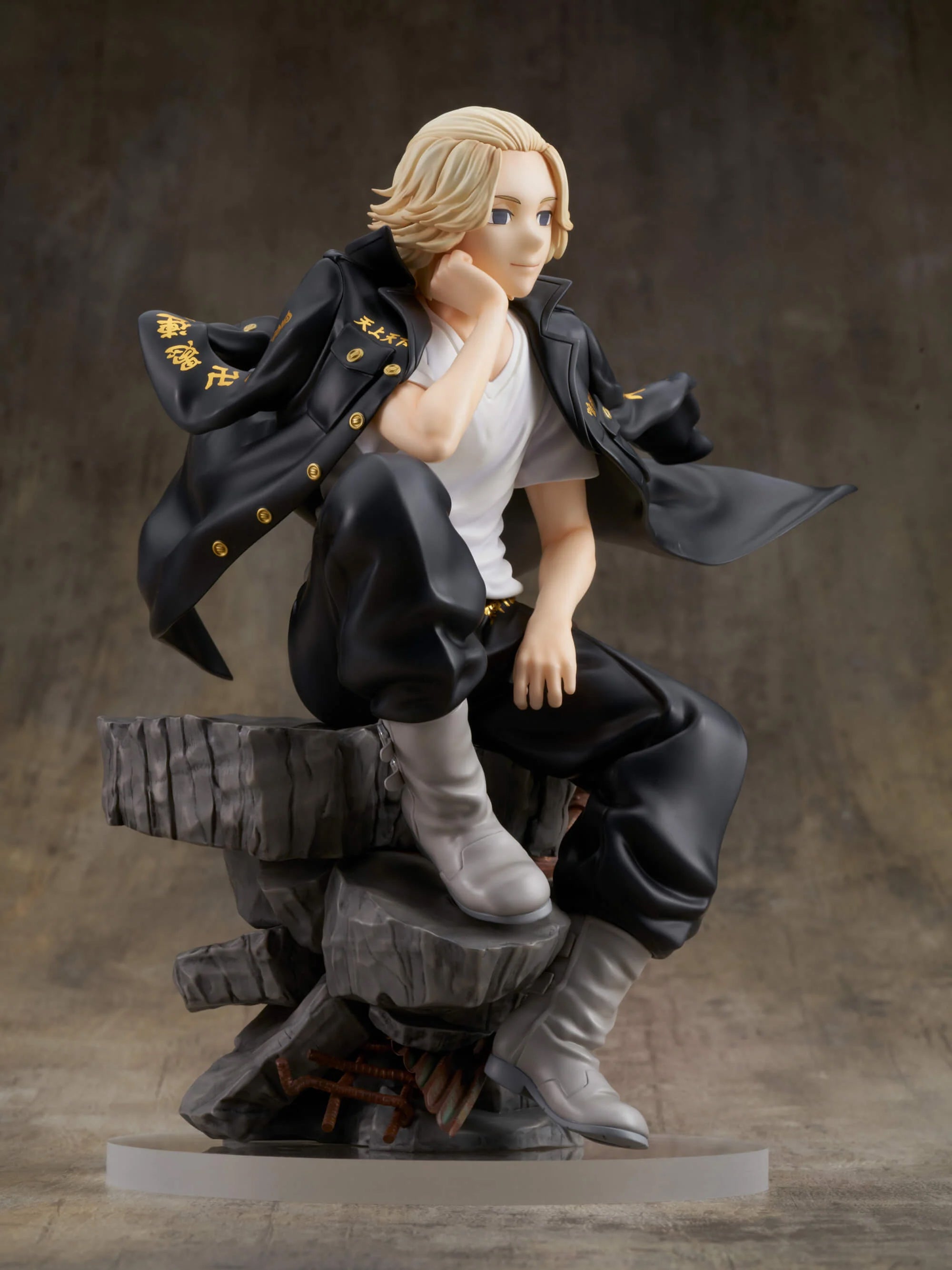 Vue 3/4 de face en plan rapproché de la figurine de Manjiro Sano de Tokyo Revengers, en t-shirt blanc et veste noire, posé sur une base rocheuse.