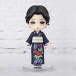 Vue 3/4 de face avec plan rapproché moyen de la figurine de Tamayo de Demon Slayer en kimono noir à motifs floraux.
