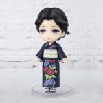 Vue 3/4 à mi-distance de la figurine Figuarts Mini de Tamayo de Demon Slayer: Kimetsu no Yaiba en kimono navy avec motifs floraux.