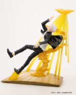 Figurine Deluxe de Gojo Satoru de la série Jujutsu Kaisen en costume sombre, en posture dynamique avec expression intense, entouré d'effets d'énergie jaune. Vue de face à distance complète.
