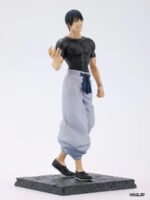 Figurine Toji Fushiguro de la série Jujutsu Kaisen en t-shirt noir et pantalon gris, en posture confiante avec un large sourire. Vue de face à mi-distance.
