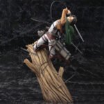 Vue 3/4 de face avec plan complet de la figurine ArtFX J de Levi Ackerman de Shingeki no Kyojin en uniforme des Corps d'Exploration, tenant des épées.