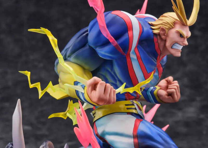 Vue 3/4 de face en gros plan de la figurine d'All Might de My Hero Academia en costume de super-héros, avec des effets d'énergie dynamique autour.