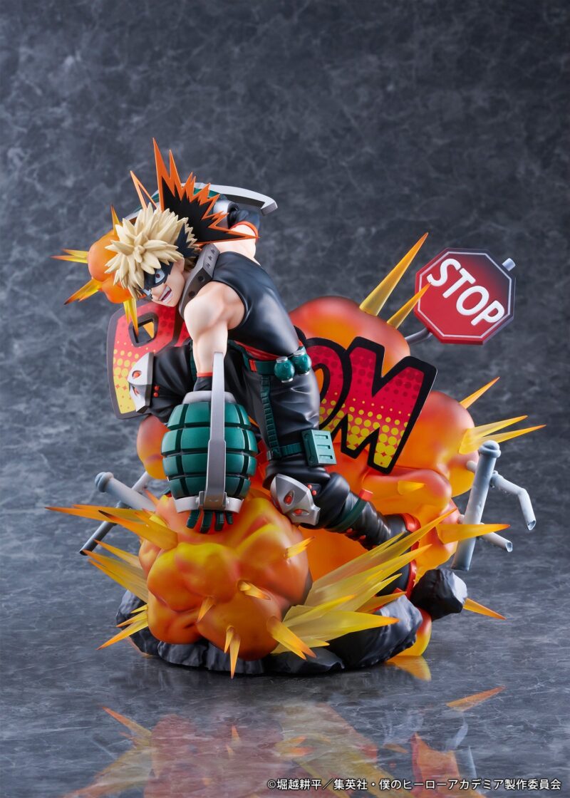 Vue 3/4 de face à mi-distance de la figurine de Katsuki Bakugo de My Hero Academia en tenue sans manches, avec des lance-grenades aux mains et des effets d'explosion.