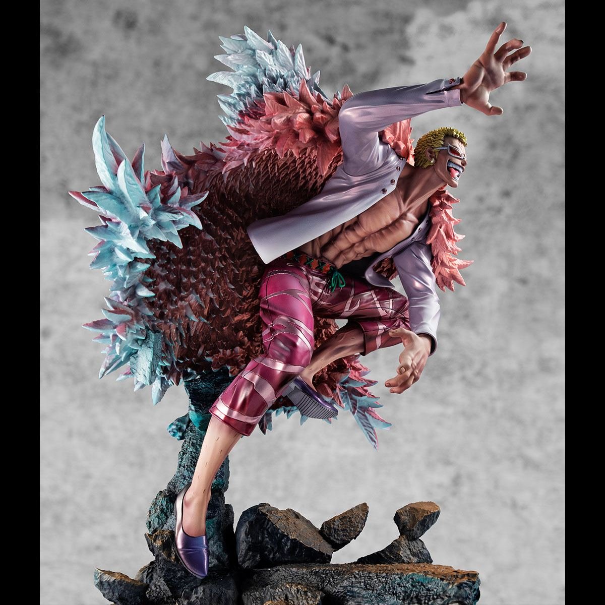 Figurine de Doflamingo portant un manteau en plumes roses et des lunettes de soleil en forme de tête de flamant rose, avec une pose dynamique et des détails colorés, fabriquée par MegaHouse.